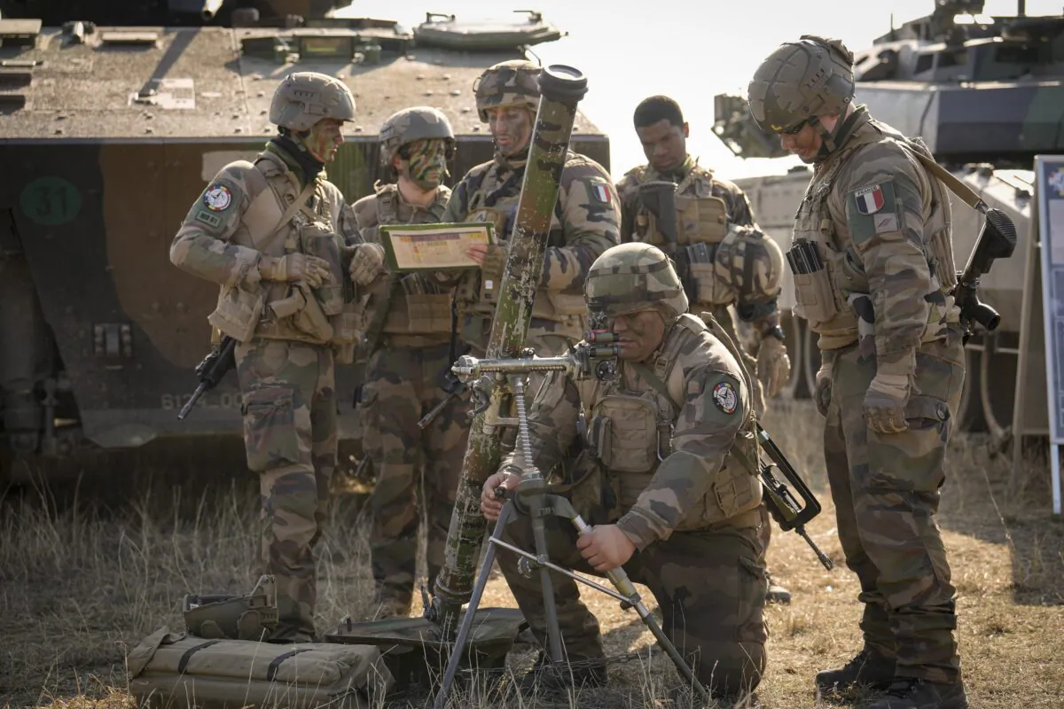 French serviceman operate a mortar during a joint French U.S. exercise involving HIMARS and MLRP rocket launchers at a firing range in Capu Midia, on the Black Sea shore, Romania, on Feb. 9, 2023. (Vadim Ghirda/AP Photo)
