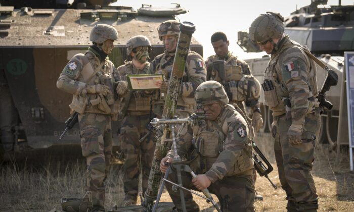 French serviceman operate a mortar during a joint French U.S. exercise involving HIMARS and MLRP rocket launchers at a firing range in Capu Midia, on the Black Sea shore, Romania, on Feb. 9, 2023. (Vadim Ghirda/AP Photo)