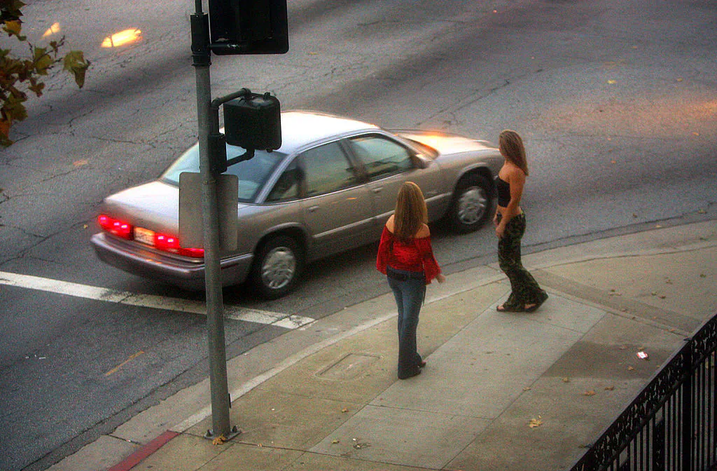 A car slows down for two female police officers posing as prostitutes on Holt Boulevard, known to sex workers throughout Southern California as "the track," during a major prostitution sting operation on Nov. 12, 2004, in Pomona, Calif. (David McNew/Getty Images)