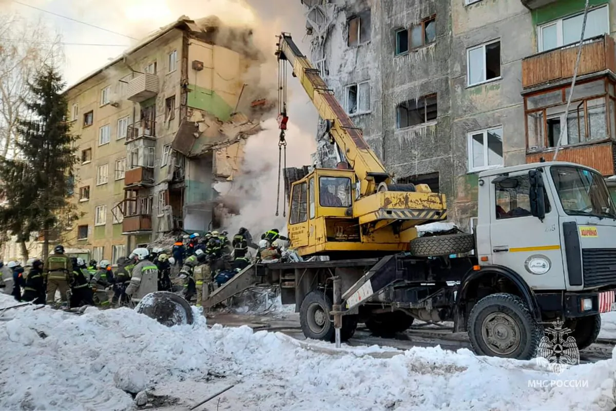 Emergency service employees work at a site of a five-story residential building collapsed after the gas explosion in the Siberian city of Novosibirsk, Russia, on Feb. 9, 2023. (Russian Emergency Ministry Press Service via AP)