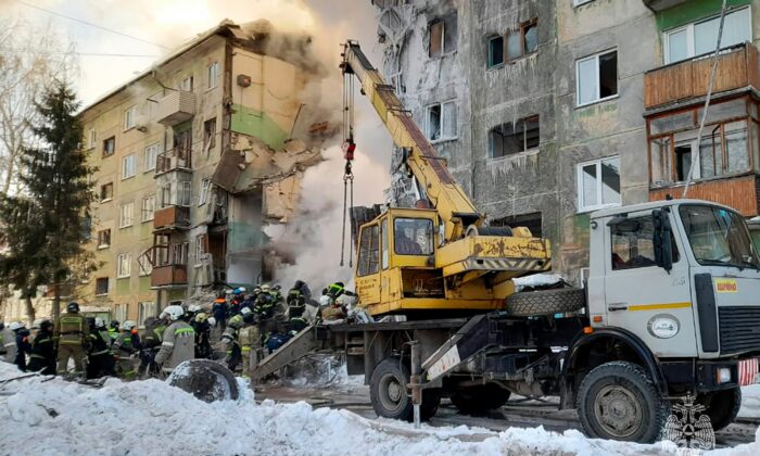 Emergency services workers work at the site of a five-story residential building that collapsed after a gas explosion in the city of Novosibirsk, Siberia, Russia, on February 9, 2023.  (Russian Ministry of Emergencies press service via AP)