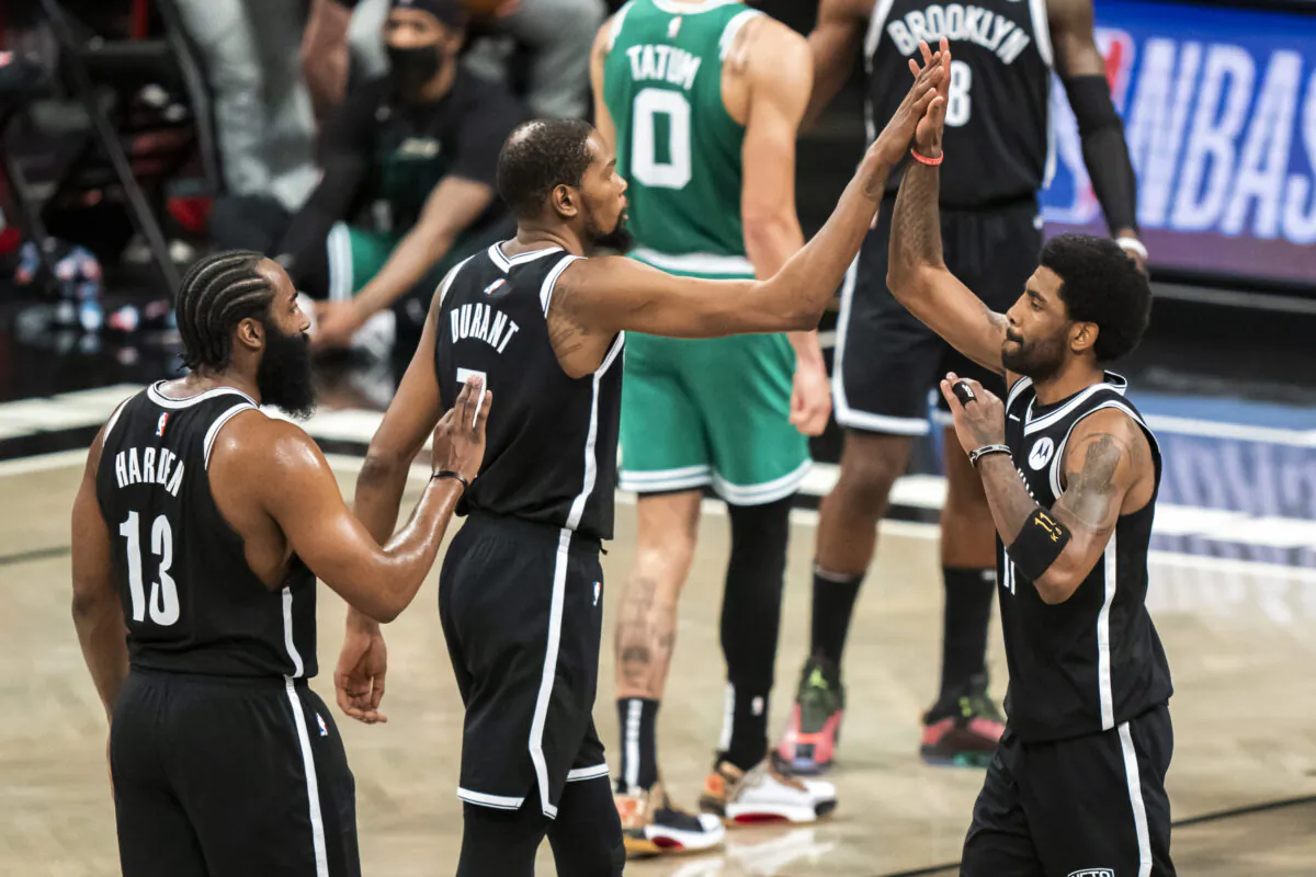 Brooklyn Nets guard James Harden (13), forward Kevin Durant (7) and guard Kyrie Irving celebrate during the first half of Game 1 of an NBA basketball first-round playoff series in New York on May 22, 2021. (Corey Sipkin/AP Photo)
