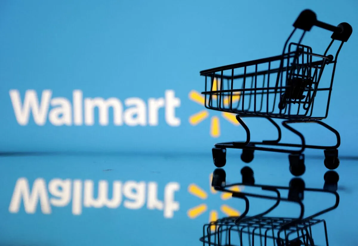 Shopping trolley in front of Walmart logo on July 24, 2022. (Dado Ruvic/Illustration/Reuters)