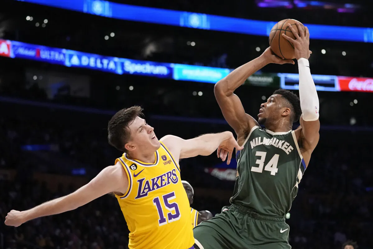 Milwaukee Bucks forward Giannis Antetokounmpo, right, shoots as Los Angeles Lakers guard Austin Reaves defends during the first half of an NBA basketball game in Los Angeles on Feb. 9, 2023. (Mark J. Terrill/AP Photo)