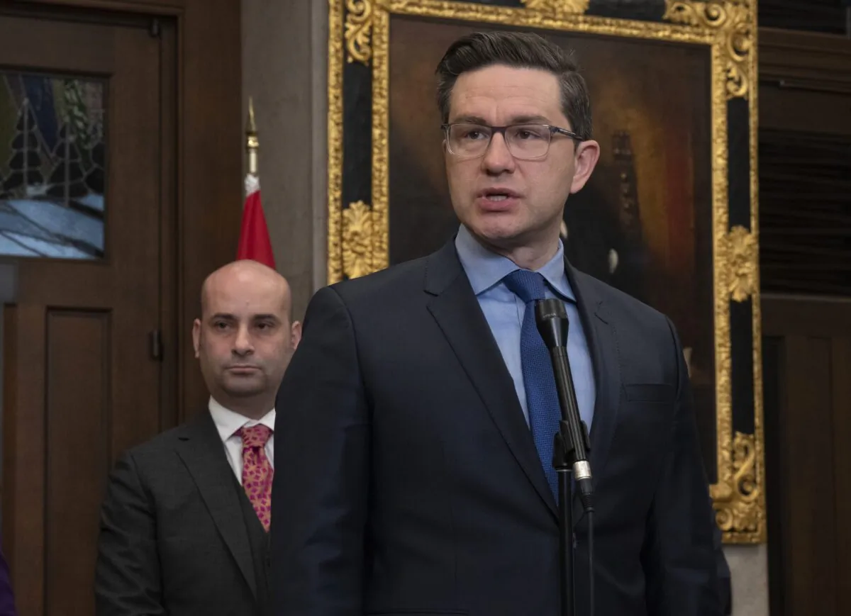 Conservative MP Frank Caputo (L) looks on as Conservative Party Leader Pierre Poilievre speaks about bail reform during a news conference in the foyer of the House of Commons on Feb. 9, 2023. (Adrian Wyld/The Canadian Press)