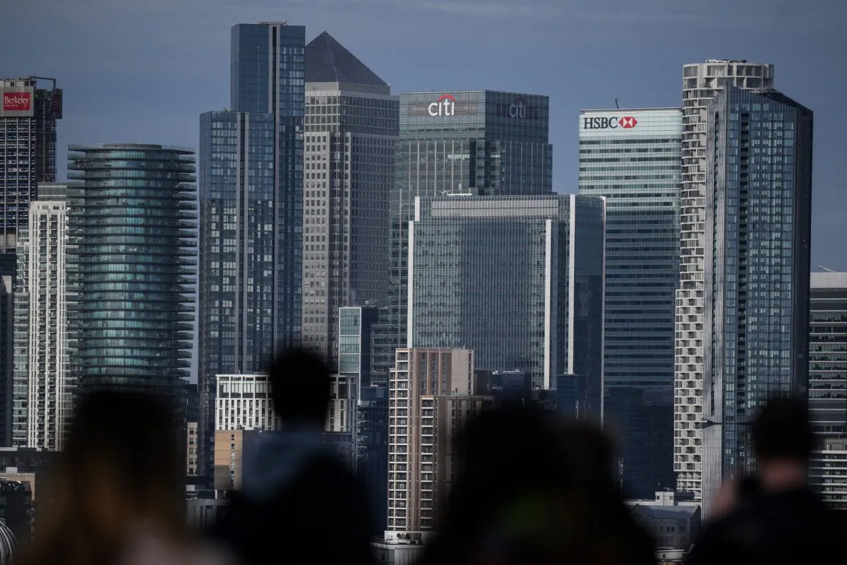 People look at Canary Wharf financial district, from Greenwich Park, southeast London, on Feb. 10, 2023. (Daniel Leal/AFP via Getty Images)