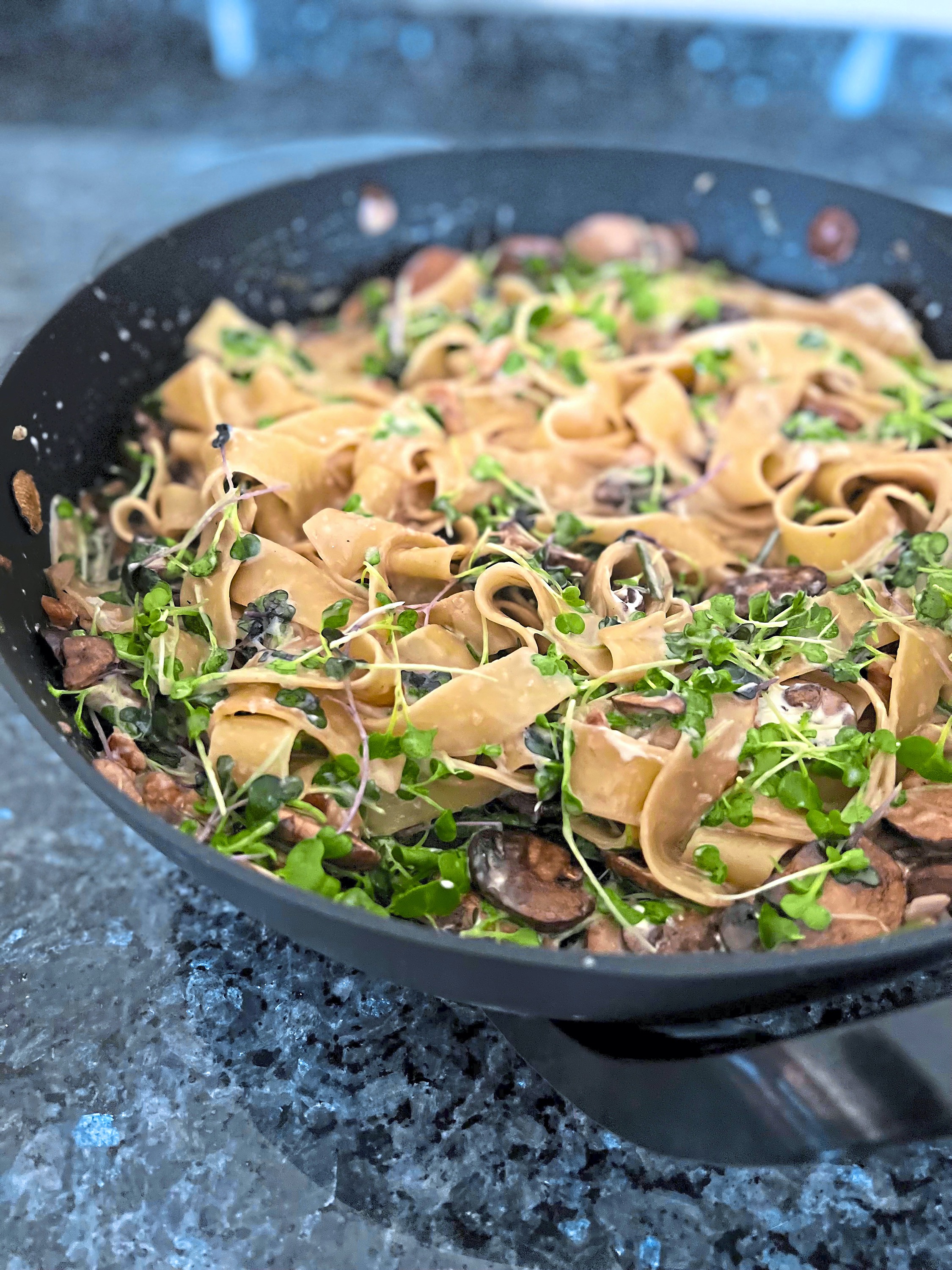 This frying pan pasta is made with fresh lasagna sheets, mushrooms and microgreens. Chopped walnuts add crunch.