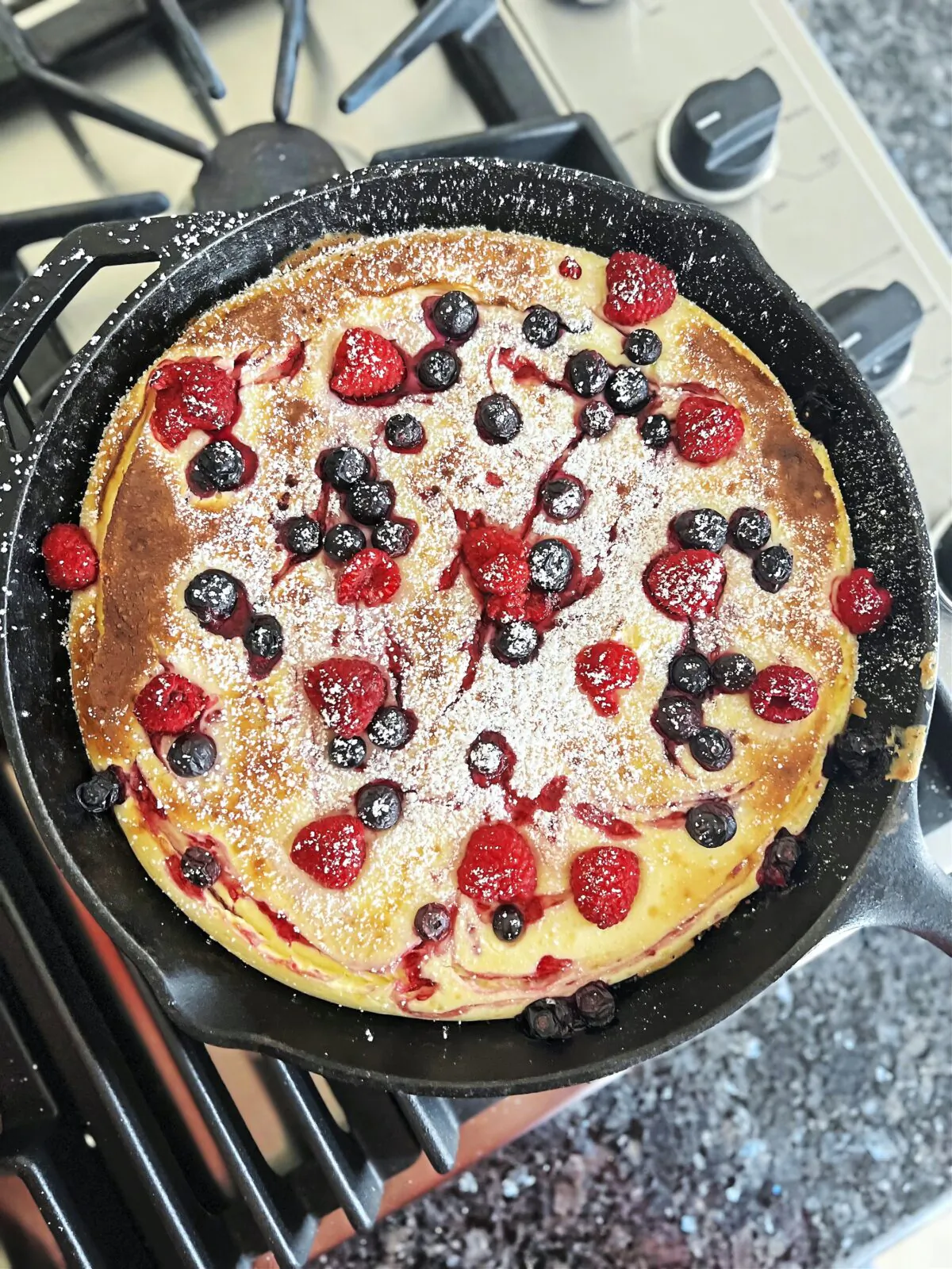 This cheesecake from Jamie Oliver is baked in a frying pan, with fresh raspberries and blueberries adding a colorful garnish. (Gretchen McKay/Pittsburgh Post-Gazette/TNS)