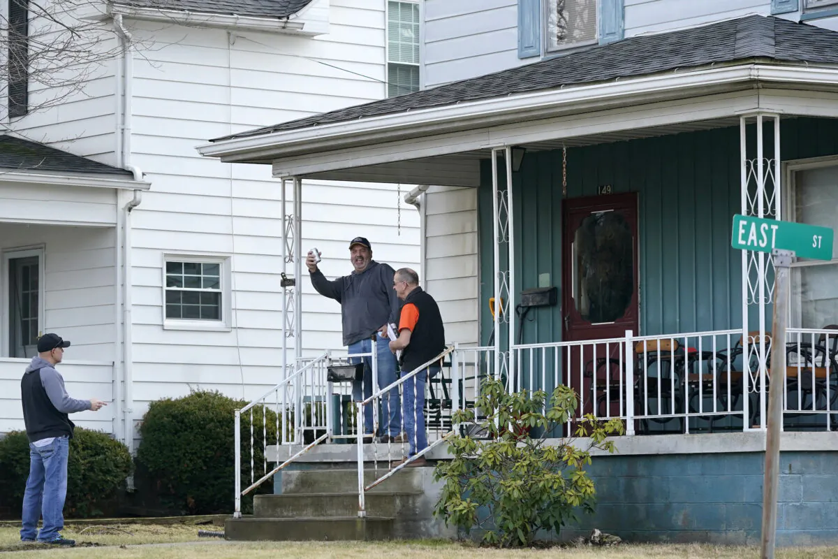 Neighbors gather outside a home in East Palestine, Pa., on Feb. 9, 2023. (Gene J. Puskar/AP Photo)