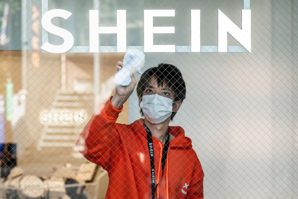 A man cleaning the windows of the first permanent showroom of Chinese online fast fashion giant Shein, during a media preview in Tokyo, Japan, on Nov. 10, 2022. (Richard A. Brooks/AFP via Getty Images)