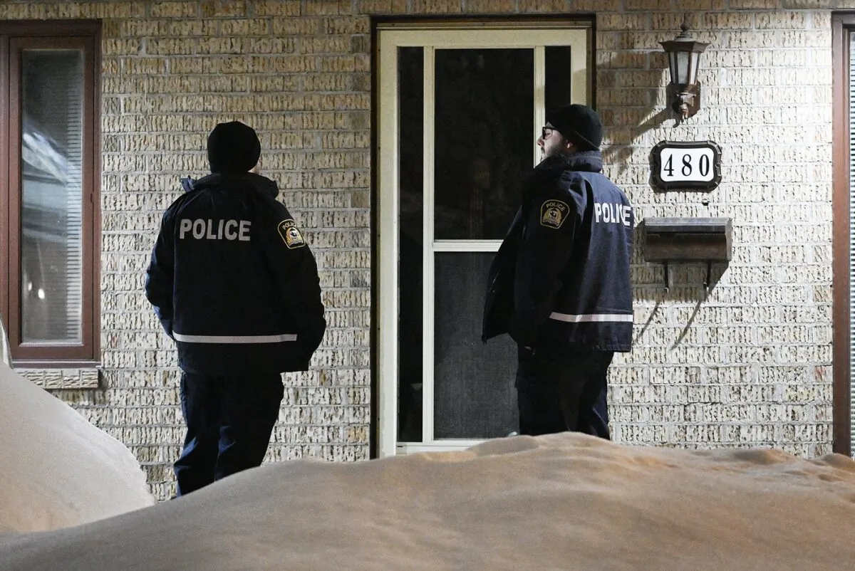 Police are shown outside the home of Pierre Ny St-Amand in Laval, Que., on Feb. 8, 2023. (The Canadian Press/Graham Hughes)