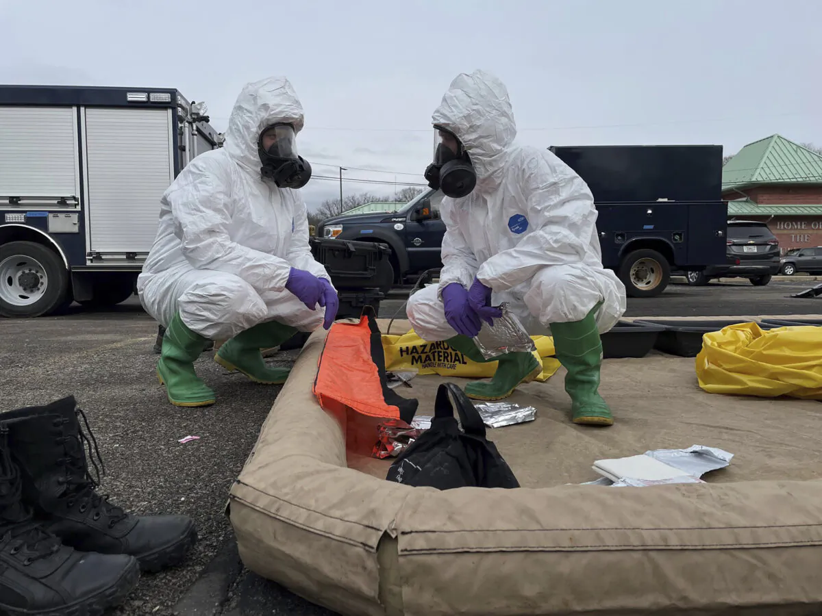 ONG 52nd Civil Support Team members prepare to enter an incident area to assess remaining hazards with a lightweight inflatable decontamination system (LIDS) in East Palestine, Ohio, on Feb. 7, 2023. (Ohio National Guard via AP)