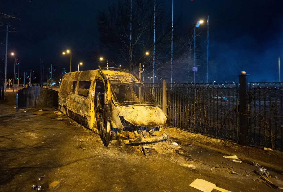 A burnt out police van after a demonstration outside the Suites Hotel in Knowsley, Merseyside, England, on Feb. 10, 2023. (Peter Powell/PA Media)