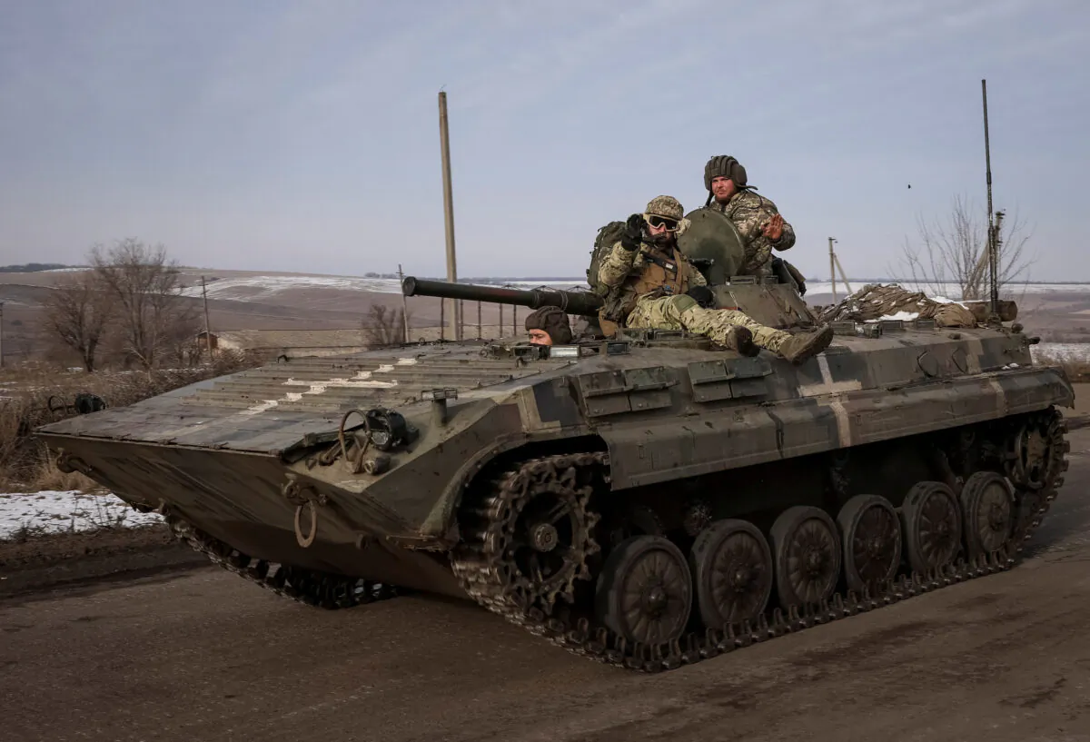 Ukrainian service members ride a BMP-2 infantry fighting vehicle, as Russia's attack on Ukraine continues, near the frontline town of Bakhmut, Donetsk region, Ukraine, on Feb. 9, 2023. (Yevhen Titov/Reuters)