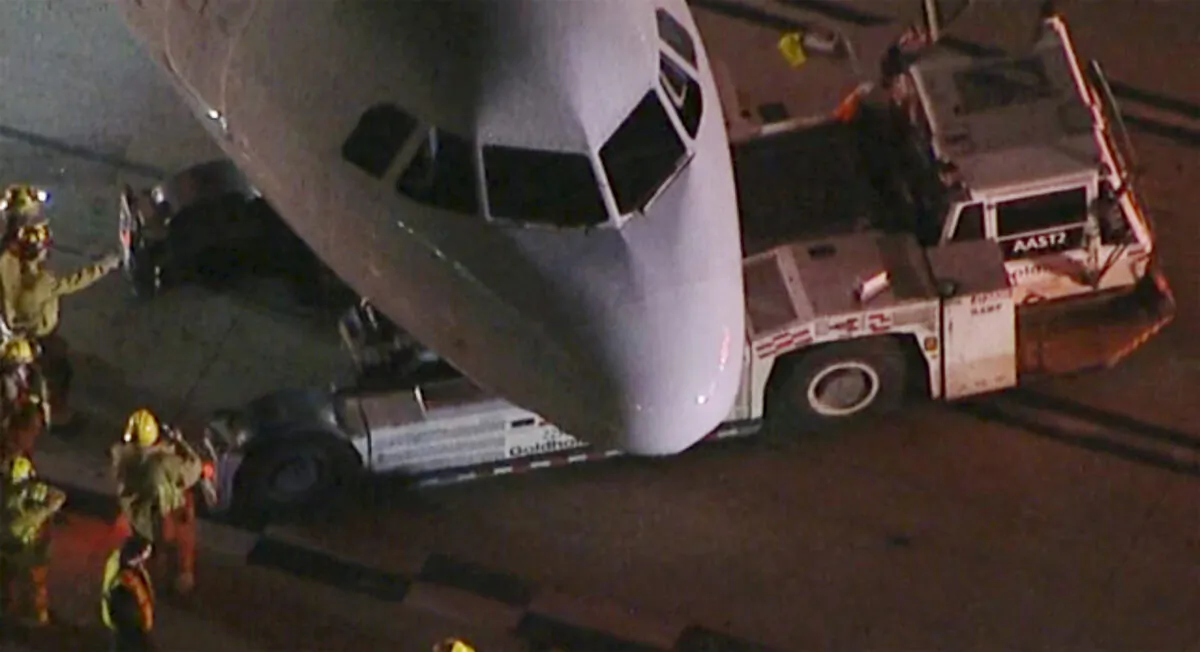 An American Airlines aircraft is damaged after a collision with a passenger bus at Los Angeles International Airport in Los Angeles early on Feb. 11, 2023. (KABC via AP)