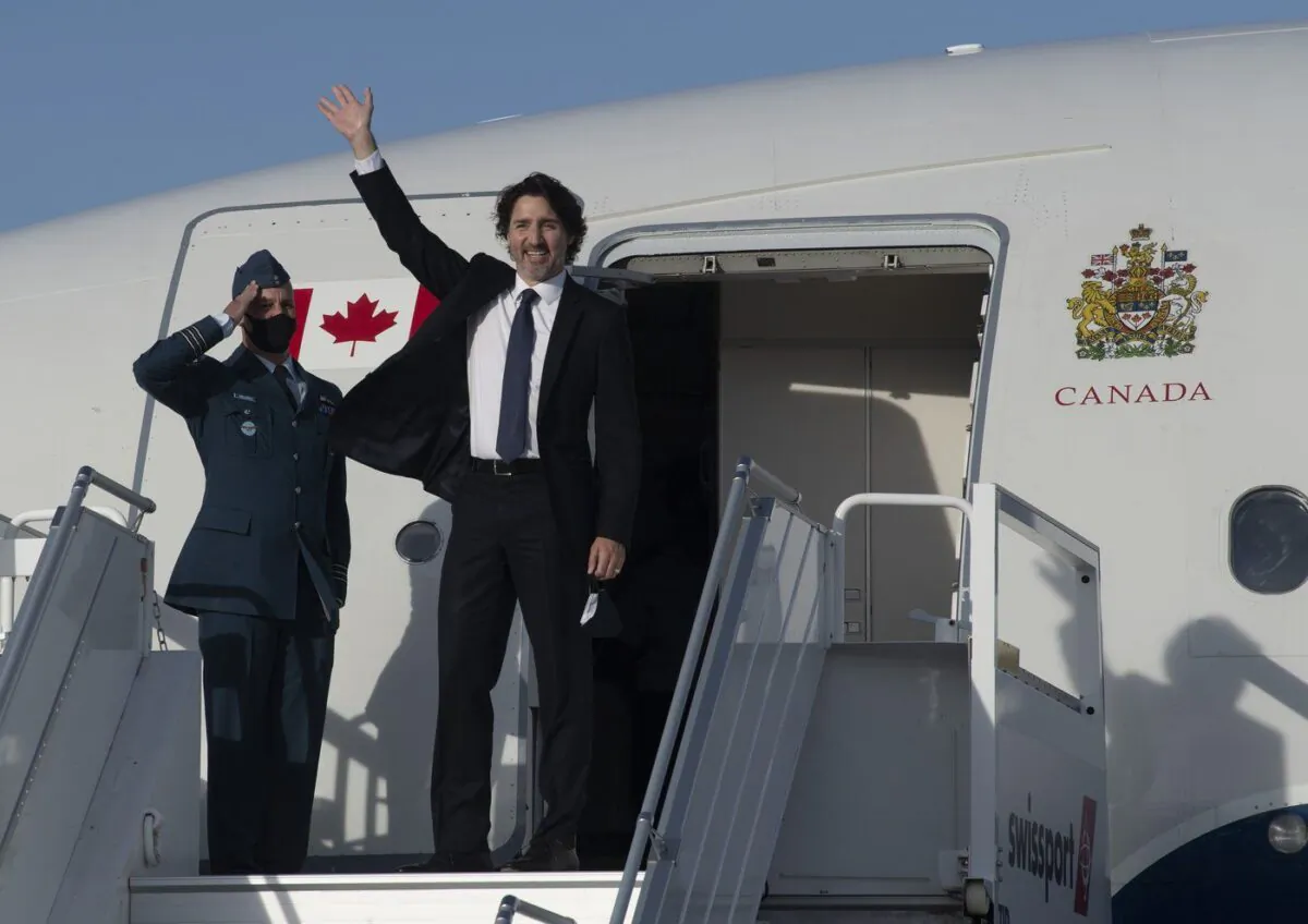 Prime Minister Justin Trudeau waves as he boards a government plane at the airport in Ottawa on June 10, 2021. (Adrian Wyld/The Canadian Press)