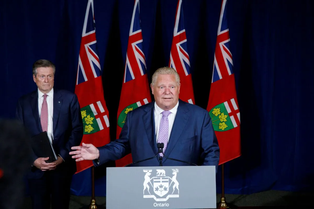 Toronto Mayor John Tory, listens to Ontario Premier Doug Ford during a joint press conference at Queen’s Park in Toronto on June 27, 2022. (The Canadian Press/Cole Burston)