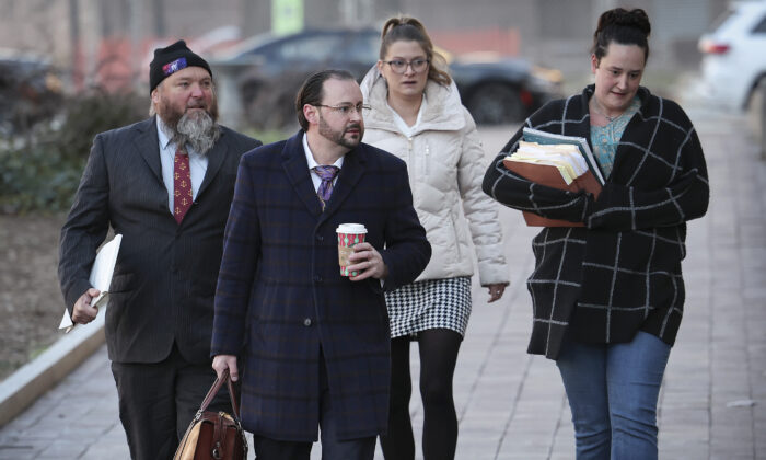 Attorney Steven Metcalf (2nd L), representing defendant Dominic Pezzola for his alleged role in the Jan. 6, 2021, Capitol breach, arrives at the E. Barrett Prettyman United States Courthouse on Dec. 19, 2022. (Win McNamee/Getty Images)