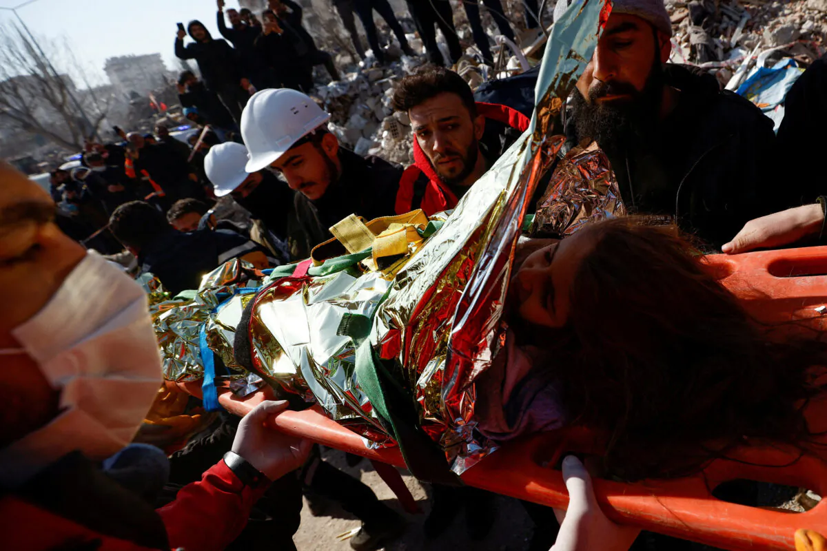 Rescuers carry Aisha, a 5-year-old Syrian girl, who survived a deadly earthquake in Kahramanmaras, Turkey, on Feb. 11, 2023. (Guglielmo Mangiapane/Reuters)