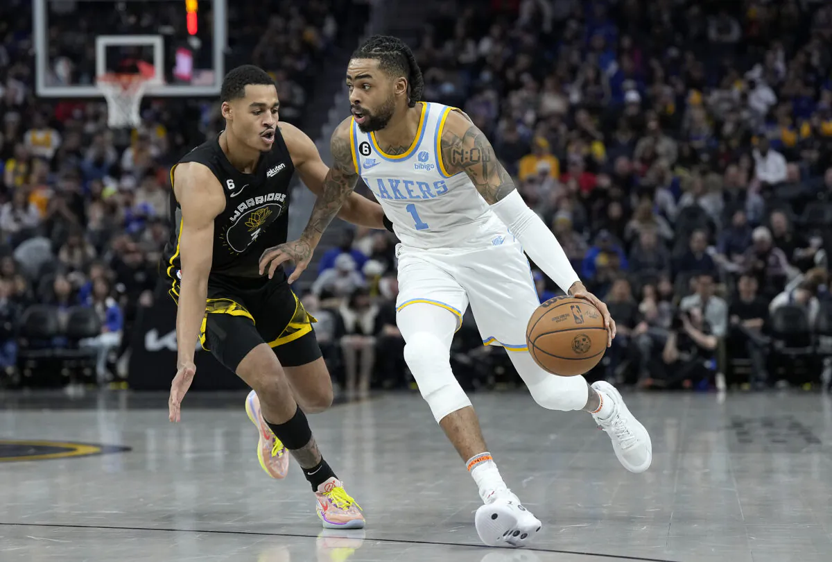 D'Angelo Russell (0) of the Los Angeles Lakers dribbles past Jordan Poole (3) of the Golden State Warriors during the third quarter at Chase Center in San Francisco on Feb. 11, 2023. (Thearon W. Henderson/Getty Images)
