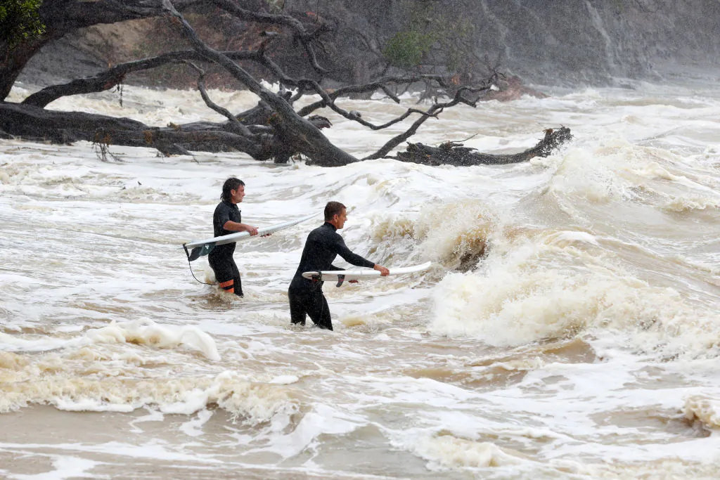 Surfers heads out into large waves and rough seas from Cyclone Gabrielle at Goat Island Marine Reserve in Auckland, New Zealand, on Feb. 13, 2023. (Fiona Goodall/Getty Images)