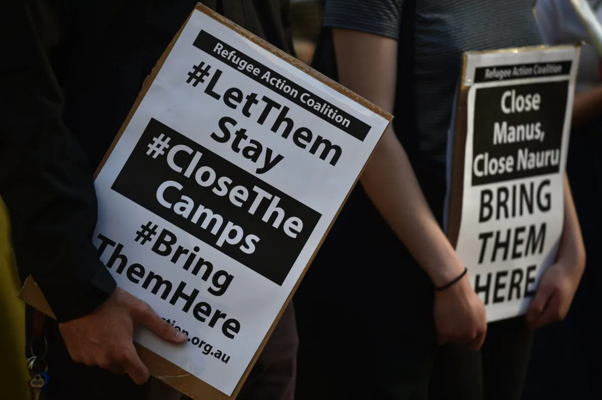 Refugee supporters hold placards as they gather to protest the Nauru refugee detention camp in Sydney, Australia, October 5, 2016. (Peter Parks/AFP via Getty Images)