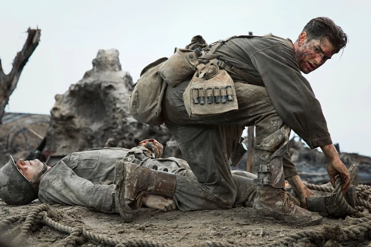 Desmond Doss (Andrew Garfield) saves wounded soldiers in WWII in a scene from “Hacksaw Ridge.” (Lionsgate)