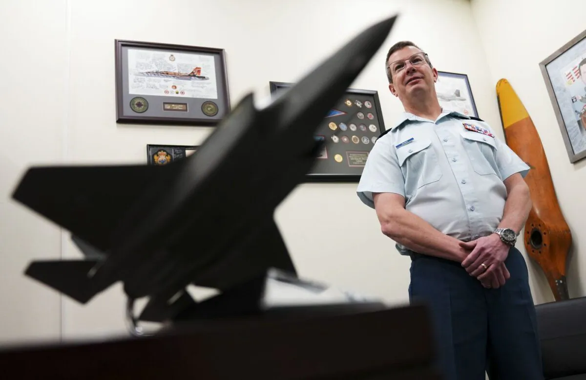A model of an F-35 fighter jet sits on the desk of Lt.-Gen. Eric Kenny as he poses for a portrait at the National Defence Headquarters (Carling) in Ottawa on Feb. 9, 2023. (The Canadian Press/Sean Kilpatrick)