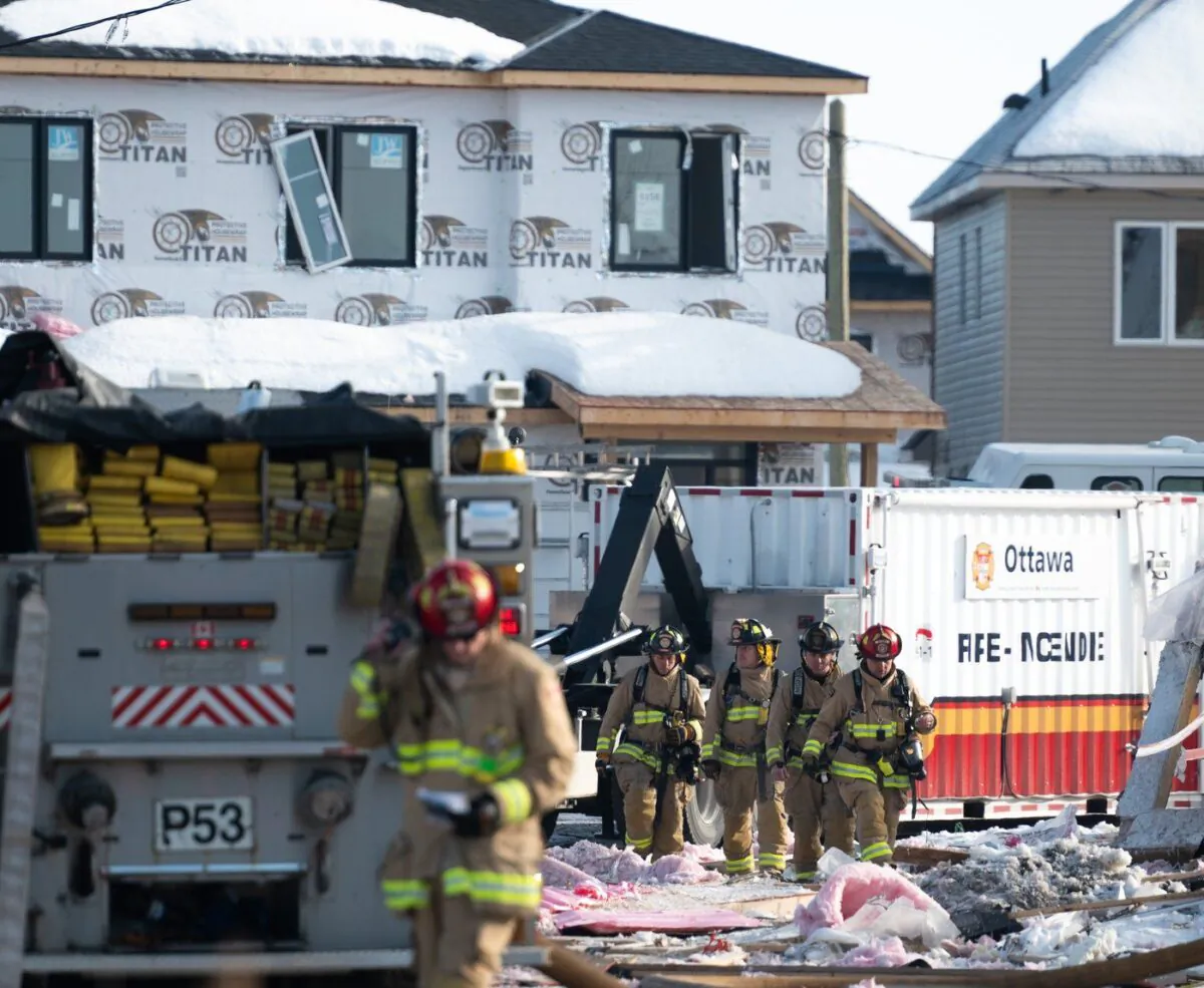 Firefighters from the Ottawa Fire Service work the scene of an early morning gas leak explosion in the Orléans area of Ottawa, on Feb. 13, 2023. (The Canadian Press/Spencer Colby)
