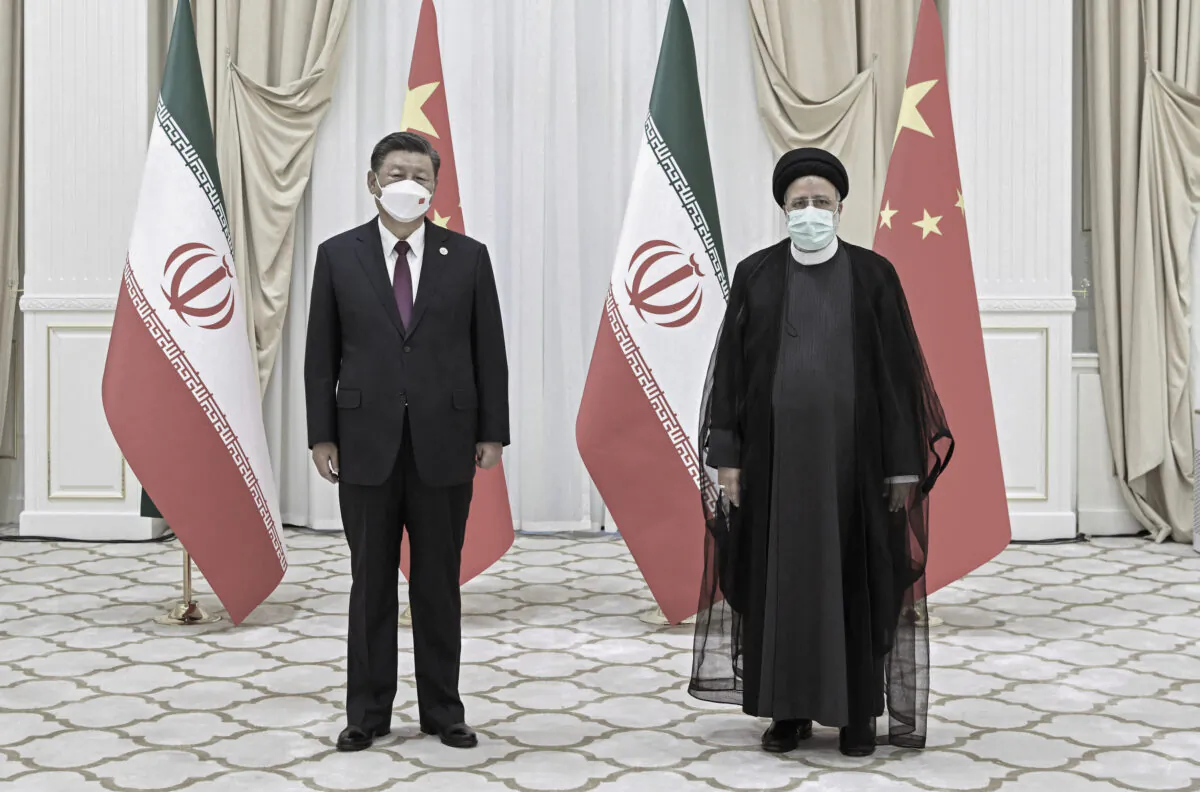 In this file photo released by China's Xinhua News Agency, then-Iranian President Ebrahim Raisi (R) and Chinese leader Xi Jinping pose for a photo on the sidelines of a meeting at the Shanghai Cooperation Organization summit in Samarkand, Uzbekistan, on Sept. 16, 2022. (Shen Hong/Xinhua via AP)