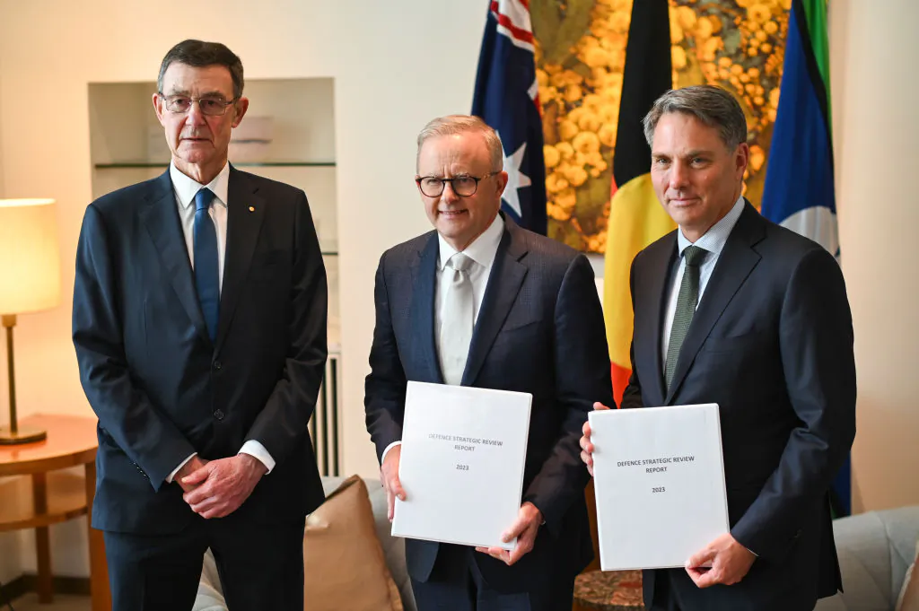 Sir Angus Houston delivers the Defence Strategic Review 2023 to Prime Minister Anthony Albanese and Deputy PM and Minister of Defence Richard Marles at Parliament House in Canberra, Australia on Feb. 14, 2023. (Martin Ollman/Getty Images)