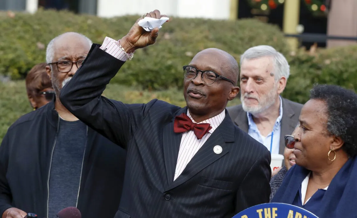 The Rev. T. Anthony Spearman, then-president of the North Carolina NAACP, crumples up a mailer which tells voters that IDs are needed in the upcoming 2020 election during a news conference outside the Legislative Building in Raleigh, N.C., on Dec. 27, 2019. (Ethan Hyman/The News & Observer via AP)