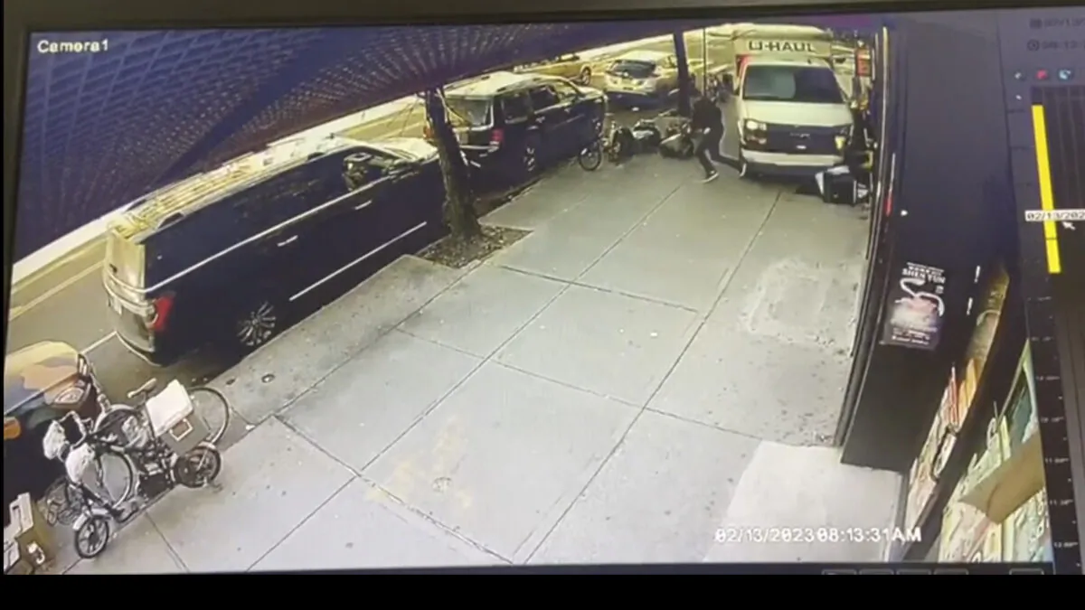 A man jumps out of the way as a U-Haul truck drives onto the sidewalk in the Brooklyn borough of New York on Feb. 13, 2023. (Jorge Aldaz via AP)