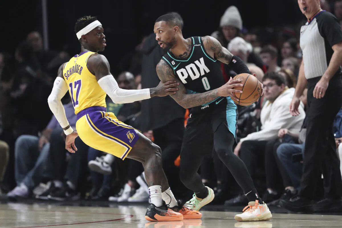 Dennis Schroder (17) of the Los Angeles Lakers defends against Damian Lillard (0) of the Portland Trail Blazers during the first quarter at Moda Center in Portland, Ore., on Feb. 13, 2023. (Amanda Loman/Getty Images)