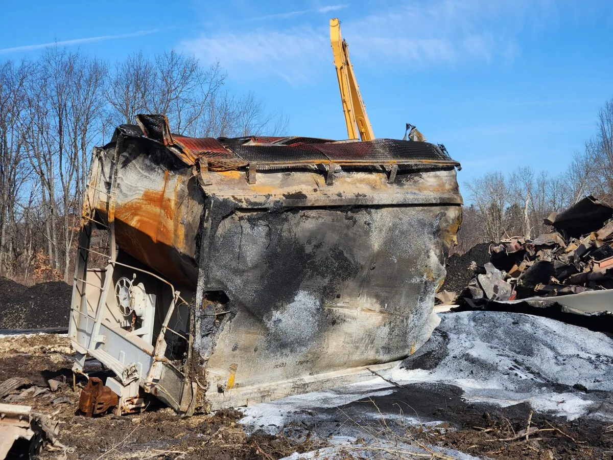 The ruins of freight cars from the Norfolk Southern Railroad train derailment are scattered around the tracks in East Palestine, Ohio, on Feb. 14, 2023. (Jeff Louderback/The Epoch Times)