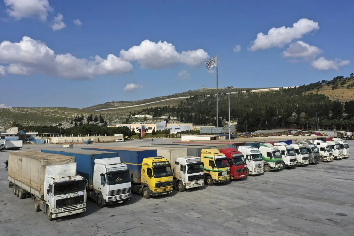 Trucks loaded with UN humanitarian aid for Syria following a devastating earthquake reach the Bab al-Hawa border crossing with Turkey, Idlib province, Syria, on Feb. 10, 2023. (Ghaith Alsayed/AP Photo)