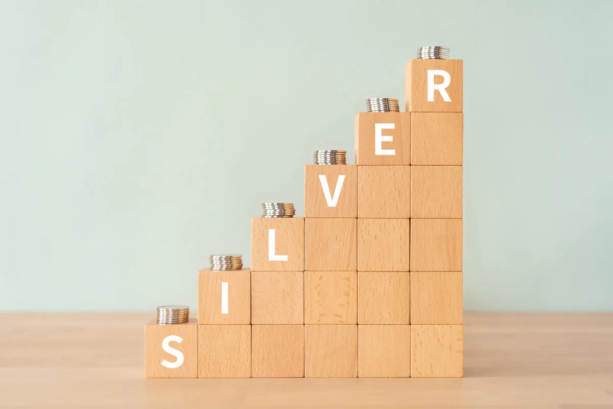 Wooden blocks with "SILVER" text of concept and coins. (ELUTAS/Shutterstock)