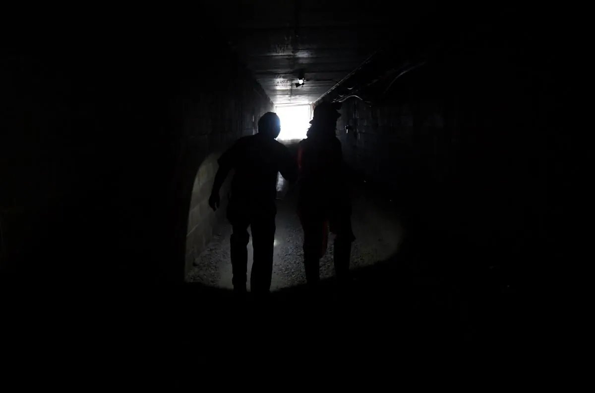  Image shows people walking in a mine shaft in Queensland (AAP Image/Dan Peled)