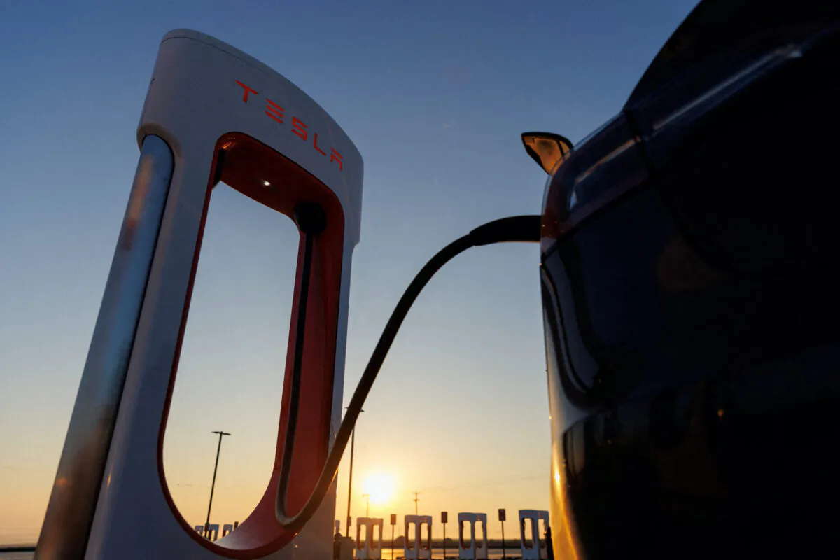 A Tesla vehicle is charged at a Tesla supercharging station in Kettleman City, Calif., on Jan. 25, 2023. (Mike Blake/Reuters)
