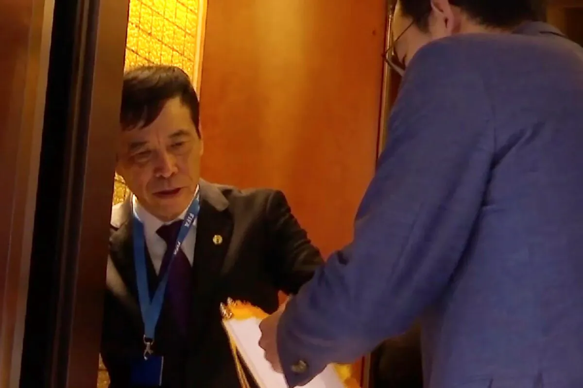 Chen Xuyuan, head of the Chinese Football Association, gets on an elevator in Shanghai on Oct. 24, 2019. (AP Photo)