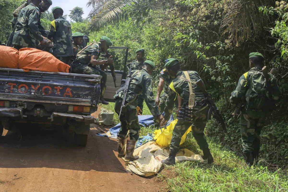 Congolese Defense Forces soldiers remove the bodies of victims of an attack near the town of Oicha, Democratic Republic of Congo, on July 23, 2021. (Al-hadji Kudra Maliro/AP Photo)