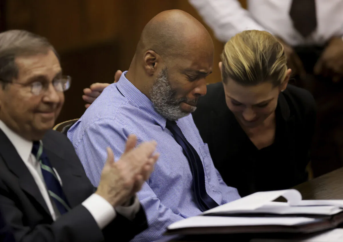Lamar Johnson (C) and his attorneys react after St. Louis Circuit Judge David Mason vacated his murder conviction during a hearing in St. Louis on Feb. 14, 2023. (Christian Gooden/St. Louis Post-Dispatch via AP, Pool)