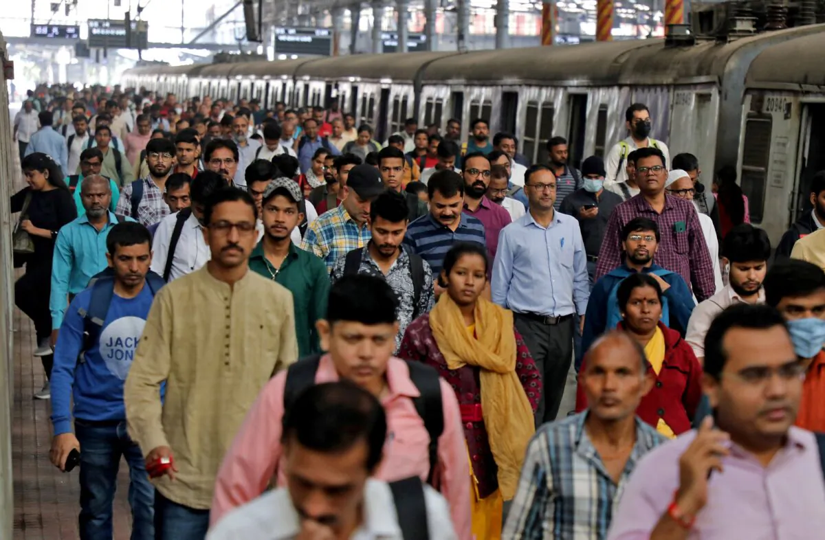 Commuters walk on a platform after disembarking from a suburban train at a railway station in Mumbai, India, on Jan. 21, 2023. (Niharika Kulkarni/Reuters)
