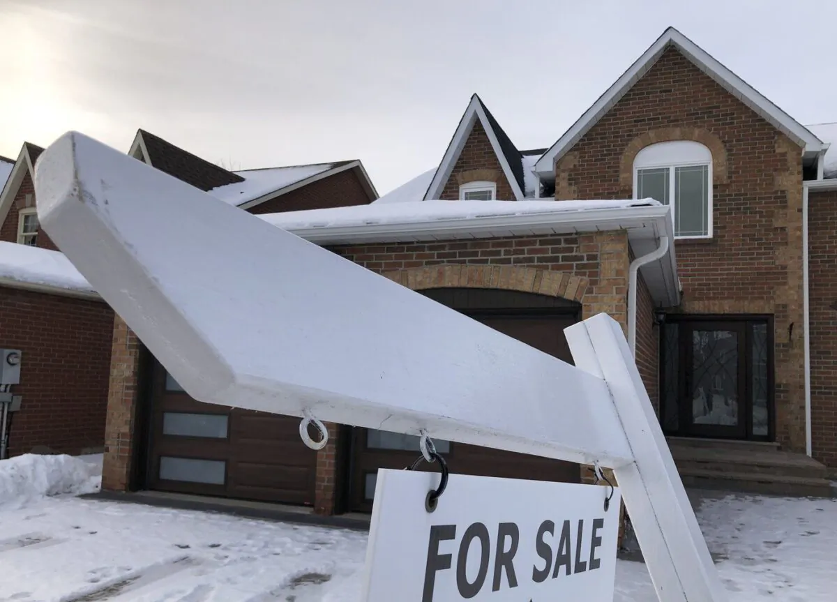 A house for sale sign is shown in front of a house in Oakville, Ont., west of Toronto, Feb.5, 2023. (The Canadian Press/Richard Buchan)
