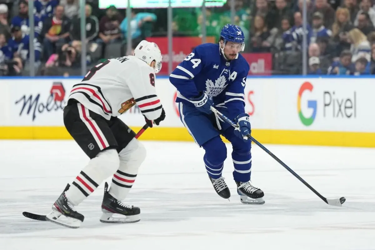 Toronto Maple Leafs center Auston Matthews (34) skates with the puck as Chicago Blackhawks defenseman Jack Johnson (8) defends during the first period at Scotiabank Arena in Toronto on Feb. 15, 2023. (Nick Turchiaro-USA TODAY Sports via Field Level Media)