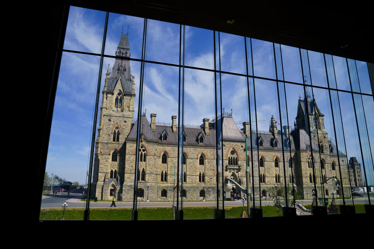 The West Block of Parliament Hill is seen through the window of the Sir John A. Macdonald building in Ottawa on May 11, 2022. (The Canadian Press/Sean Kilpatrick)