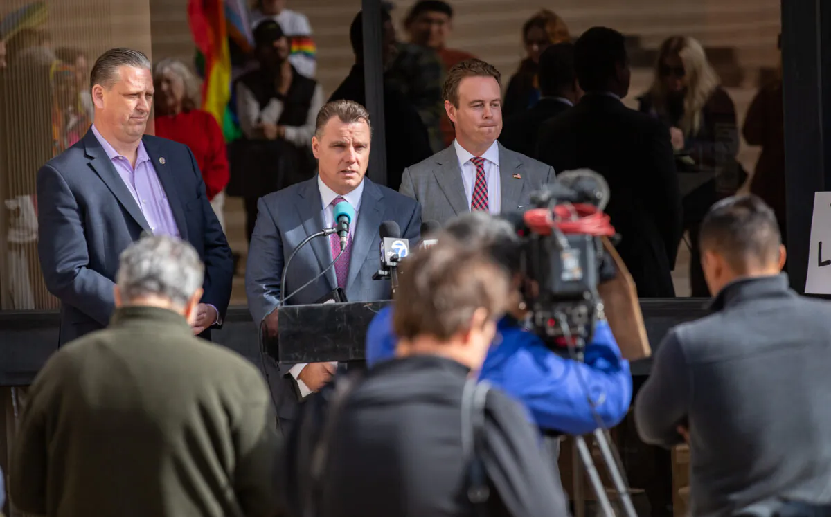 (L-R) Huntington Beach Mayor Tony Strickland, City Attorney Michael Gates, and Councilman Casey McKeon gather with residents to challenge state housing laws in Huntington Beach, Calif., on Feb. 14, 2023. (John Fredricks/The Epoch Times)