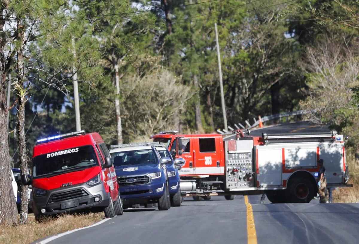 Rescue teams work at the site of the accident of a bus, which was carrying migrants who had traveled through the Darien gap, in Los Planes de Gualaca, Panama, on Feb. 15, 2023. (Stringer/Reuters)