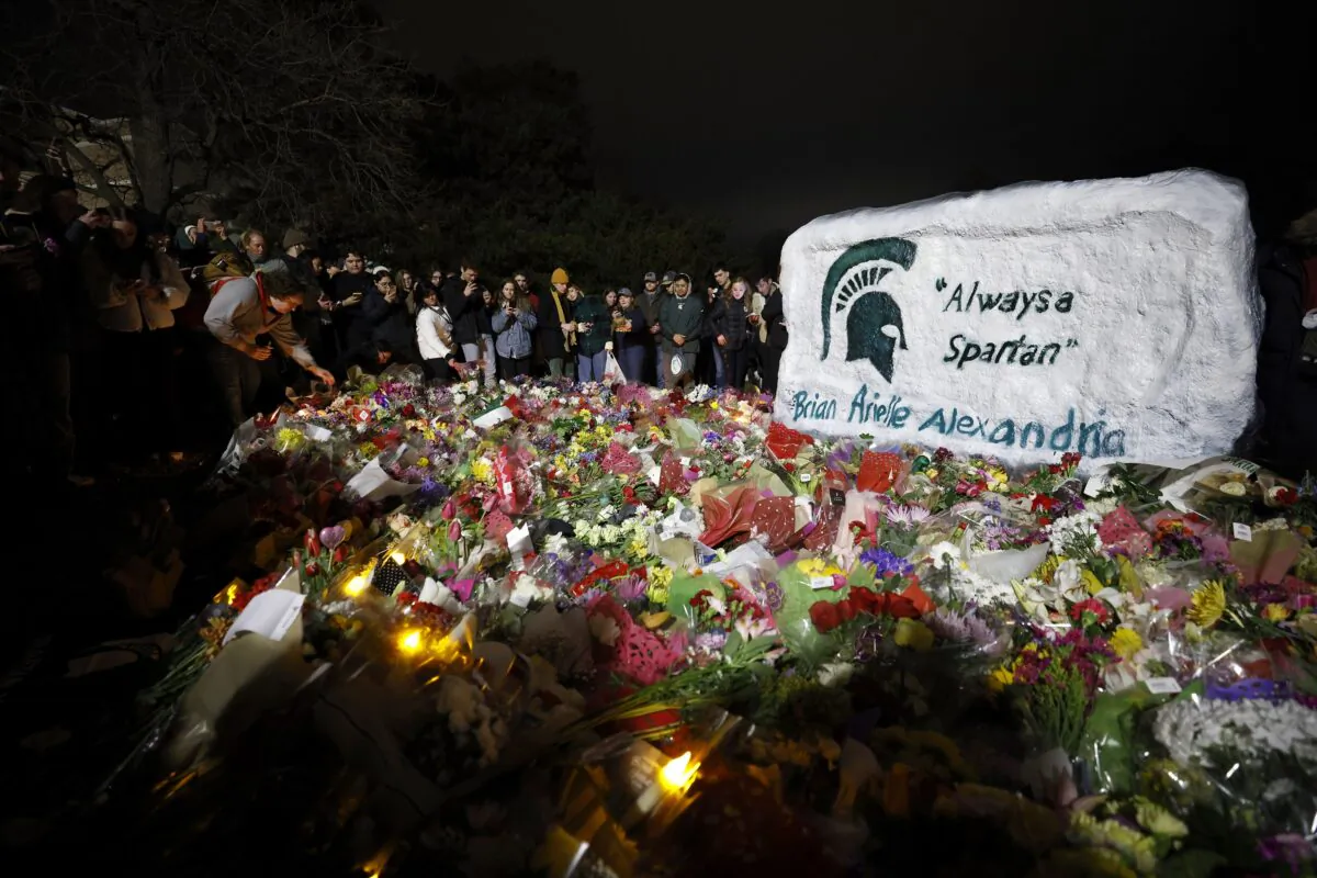 Mourners attend a vigil at The Rock on the grounds of Michigan State University in East Lansing, Mich., on Feb. 15, 2023. (Al Goldis/AP Photo)
