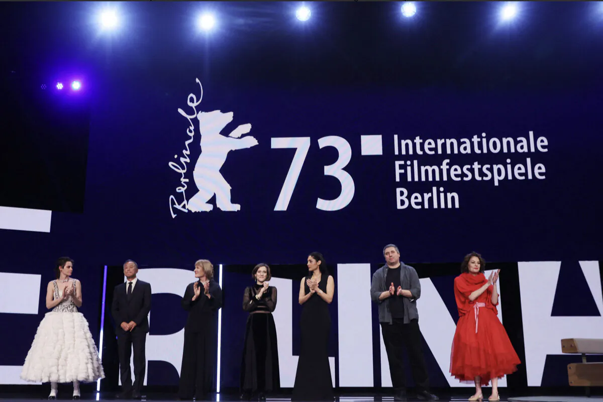 (L-R) US actress and Berlinale jury President Kristen Stewart, jury members Hong Kong film director Johnnie To, German film director Valeska Grisebach, Spanish film director Carla Simon, Iranian-French actress Golshifteh Farahani, Romanian film director Radu Jude and US casting director Francine Maisler react on stage during the Opening Gala of the Berlinale, Europe's first major film festival of the year, in Berlin on February 16, 2023. (Photo by Ronny HARTMANN / AFP)